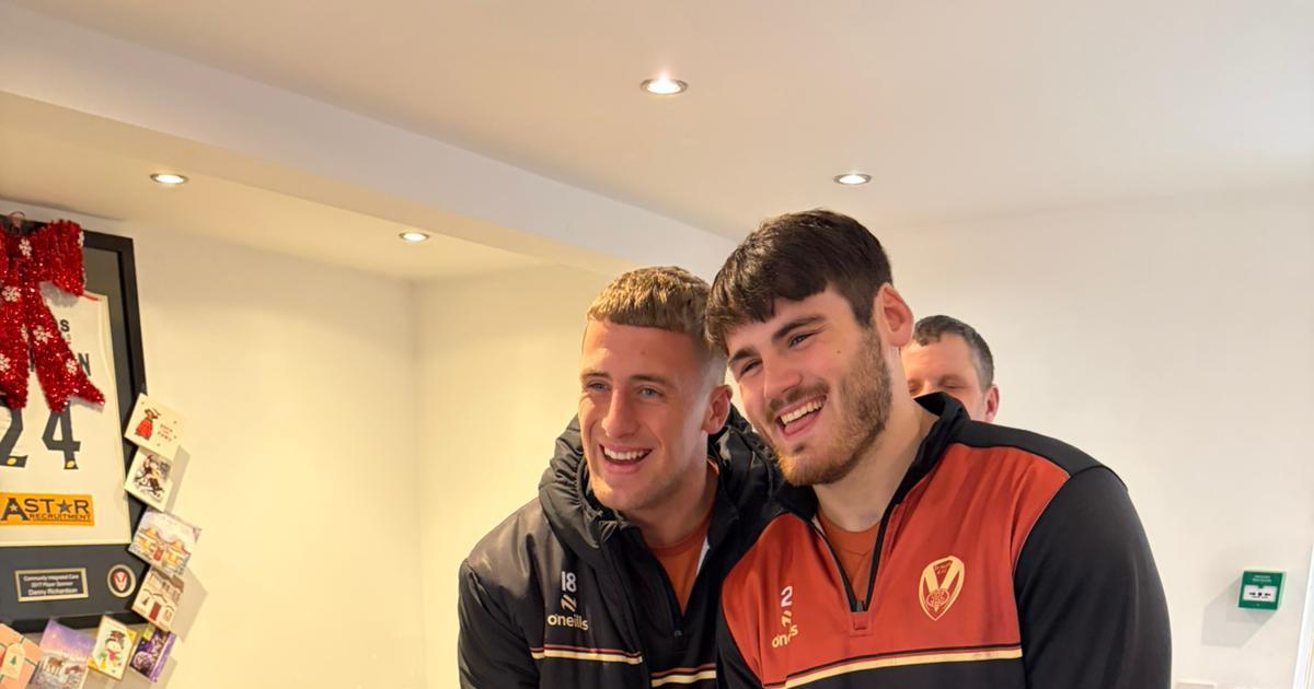 Saints players bring festive cheer to a group of supporters