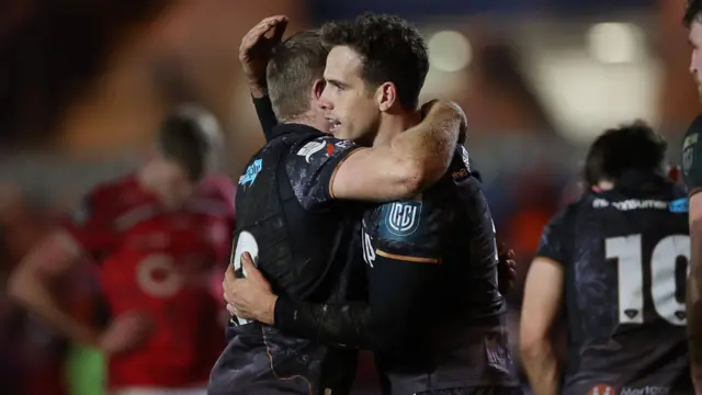 Ospreys players embrace at full time