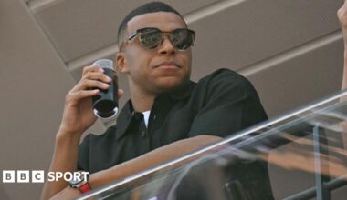 Kylian Mbappe stands on the balcony in the pit lane of the Circuit de Monaco for an F1 race