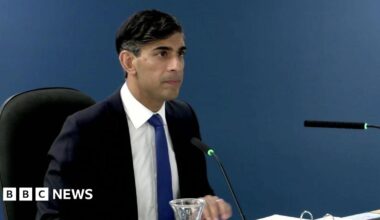 Rishi Sunak sitting down at the Covid inquiry giving evidence. He is wearing a dark-blue suit with a white shirt and royal blue tie.