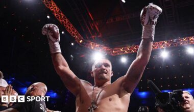 Oleksandr Usyk celebrates victory over Daniel Dubois with his arms raised