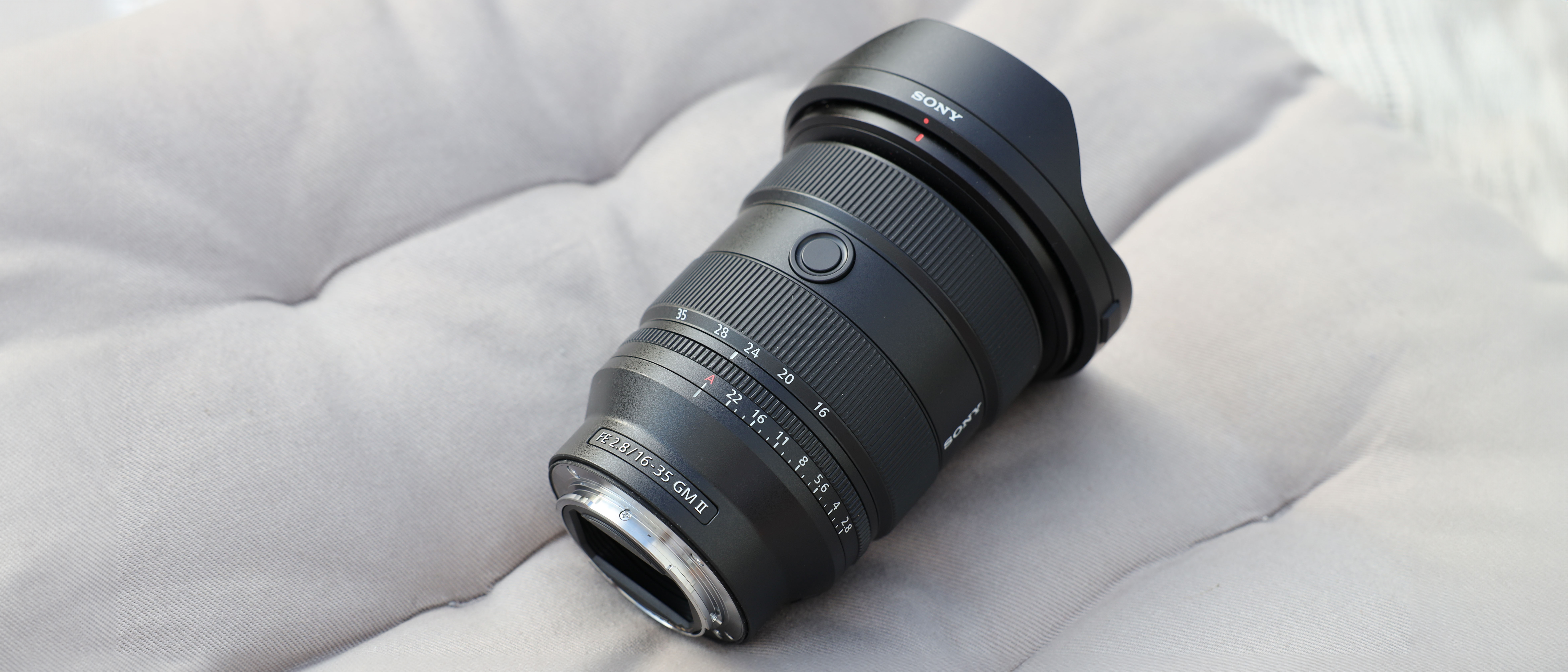 A Sony FE 16-35mm f/2.8 GM II lens on white material