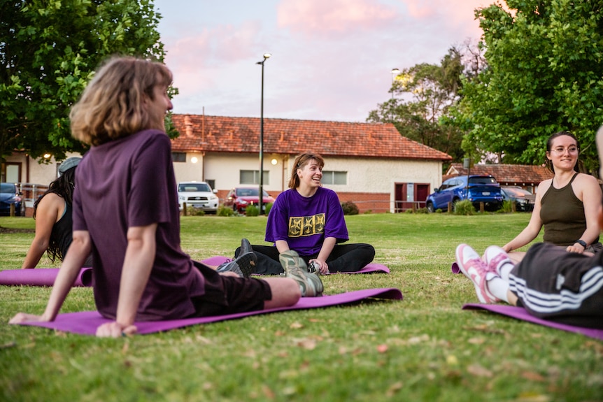 Participants smiling in a boxing class.