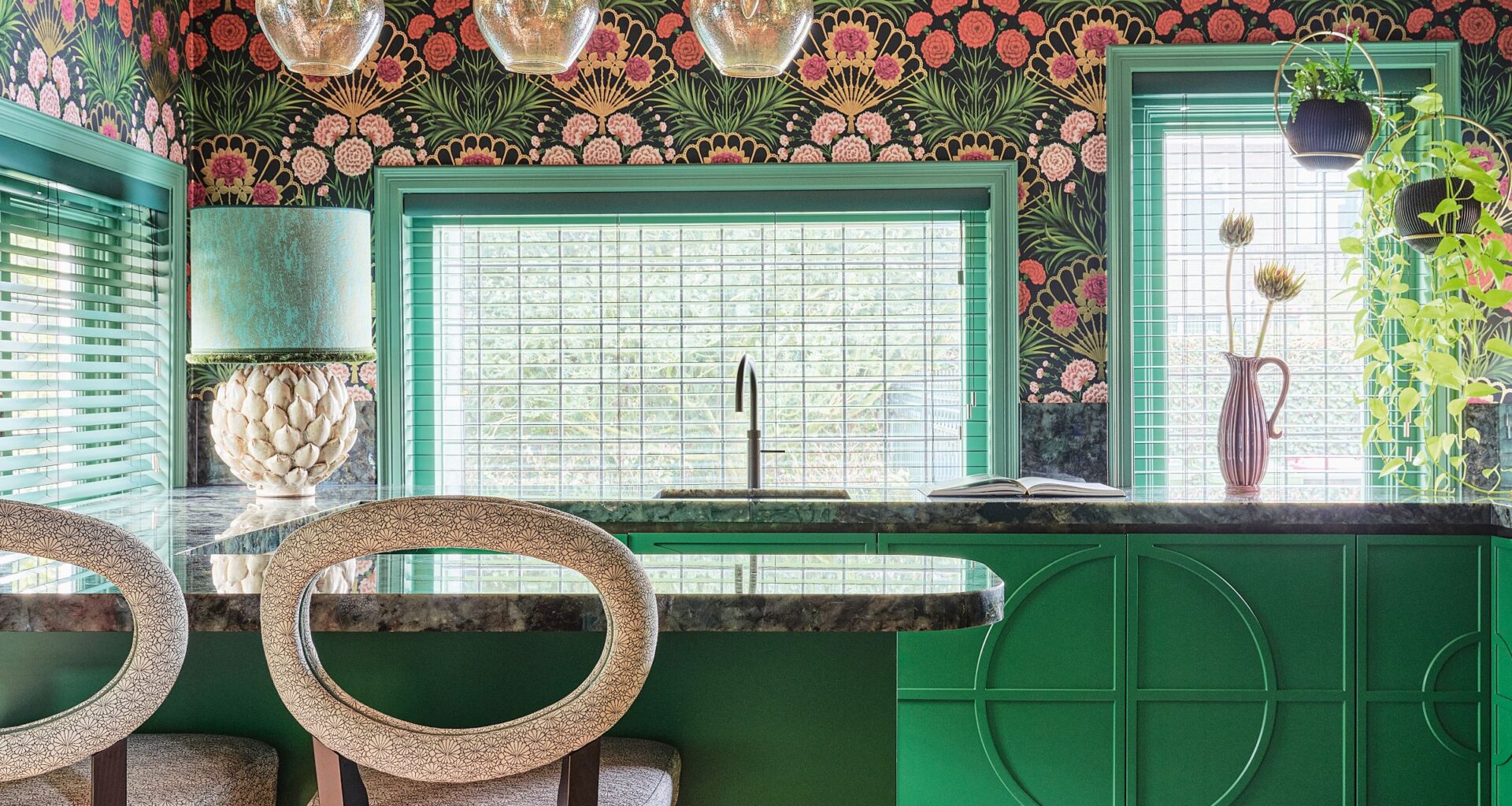 Kitchen with green cabinets, grey stone worktops, green and pink wallpaper and pink ceiling