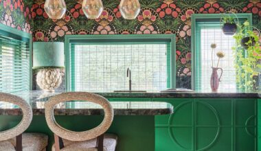 Kitchen with green cabinets, grey stone worktops, green and pink wallpaper and pink ceiling