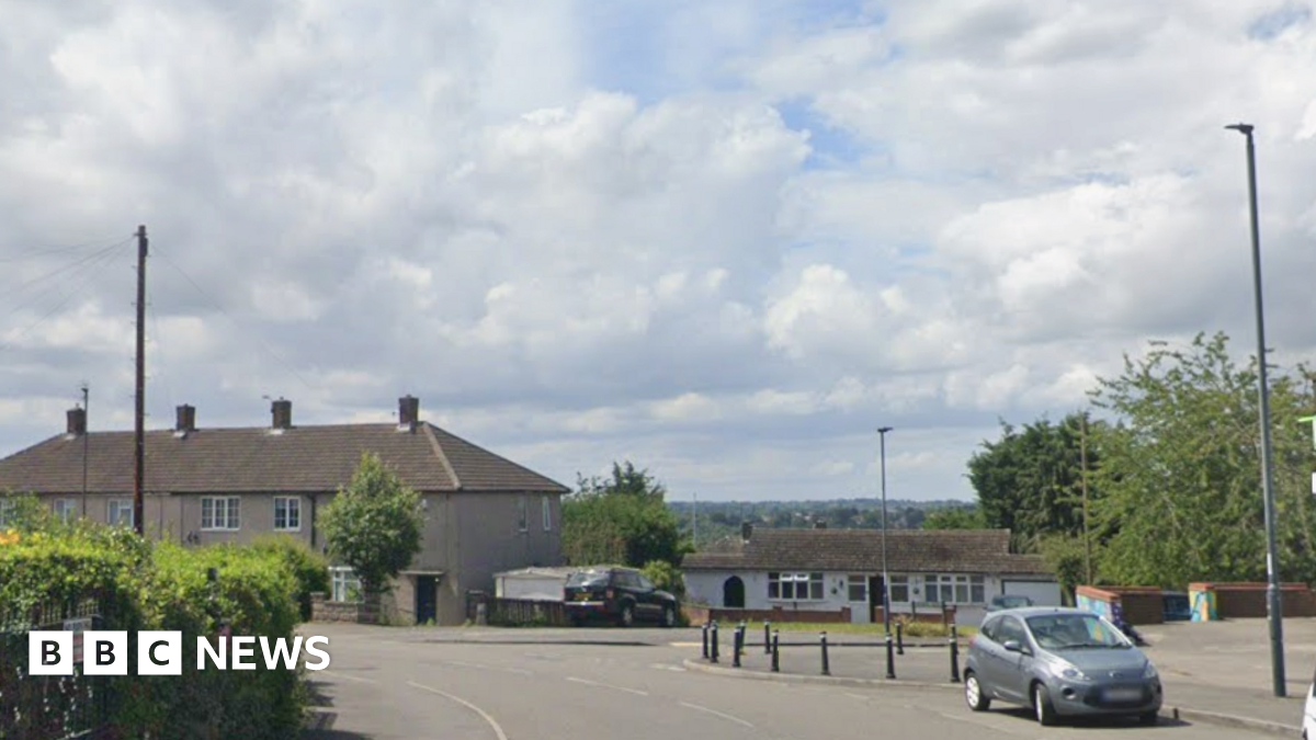 Google image of a Road with houses and a car