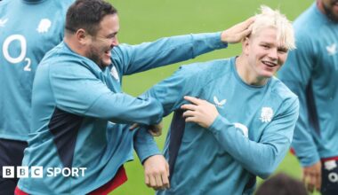 Jamie George ruffles Henry Pollock's hair during a training session