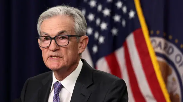 Federal Reserve Chair Jerome Powell in front of an American flag