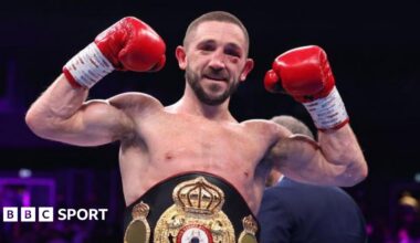 Jazza Dickens is wearing red boxing gloves and holding up his fists