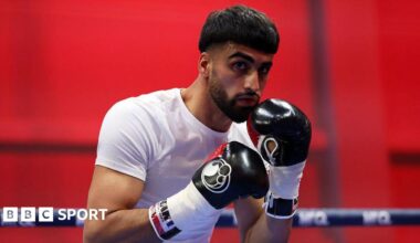 Adam Azim with his hands up