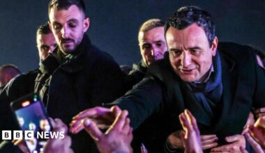 Acting Prime Minister Albin Kurti extends his right arm towards supporters as he greets them in Pristina, Kosovo