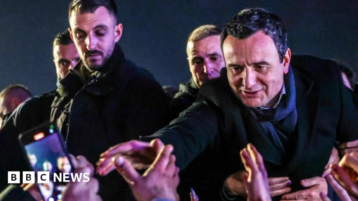 Acting Prime Minister Albin Kurti extends his right arm towards supporters as he greets them in Pristina, Kosovo