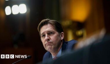 Ben Sasse sits in front of microphone