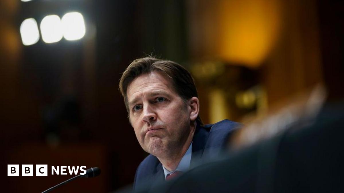 Ben Sasse sits in front of microphone