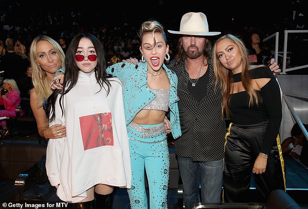 It has also been been reported that Noah has remained 'very loyal' to her father, Billy Ray, after her parents' split, while sisters Miley and Brandi sided with their mother (Tish, Noah, Miley, Billy Ray and Brandi pictured in 2017)