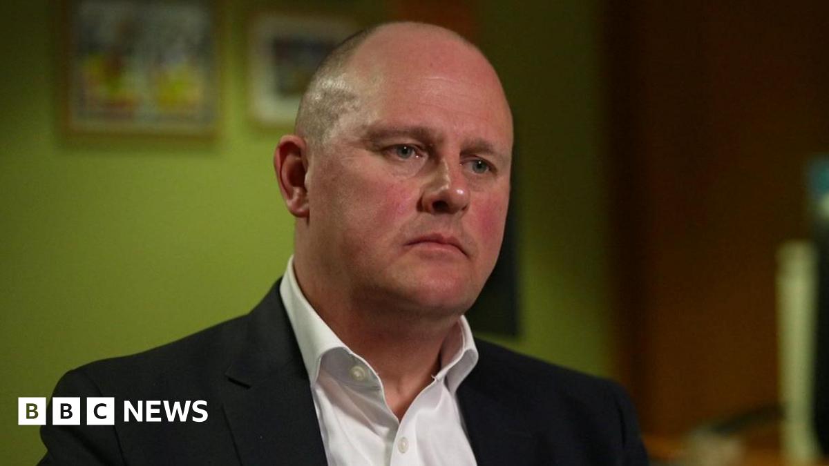 Paul Nowak, wearing a black suit and white shirt