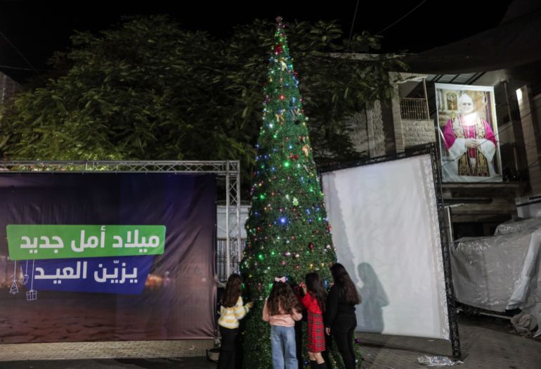 The Christmas tree is lit at the church in Gaza during prayers, with celebrations subdued due to the conditions in the Strip 