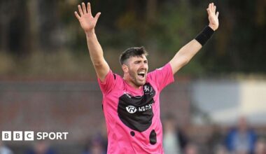 Craig Overton holds his arms aloft