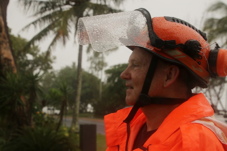 man in ses uniform looking out, it's raining