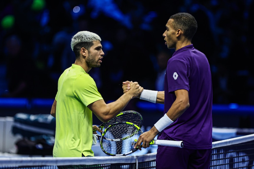Felix Auger-Aliassime shakes hands with Carlos Alcaraz