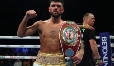 Joe Cordina raises his fist while holding the WBO lightweight title belt inside the ring after defeating Gabriel Flores Jr. at Stockton Arena in Stockton, California.
