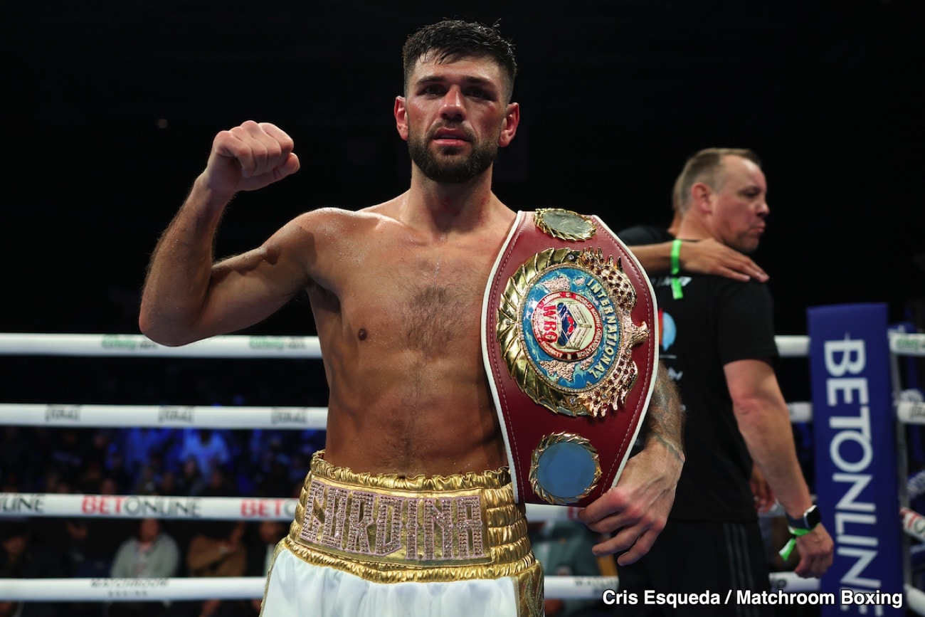 Joe Cordina raises his fist while holding the WBO lightweight title belt inside the ring after defeating Gabriel Flores Jr. at Stockton Arena in Stockton, California.