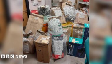 A pile of parcels on the floor in a evidence store room