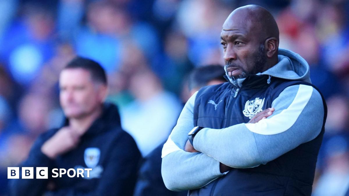 Darren Moore stand with his arms crossed watching on from the touchline during a game