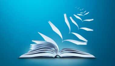 Conceptual image of reading book with pages flying away