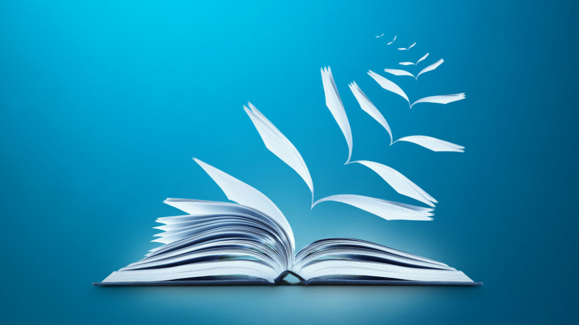 Conceptual image of reading book with pages flying away