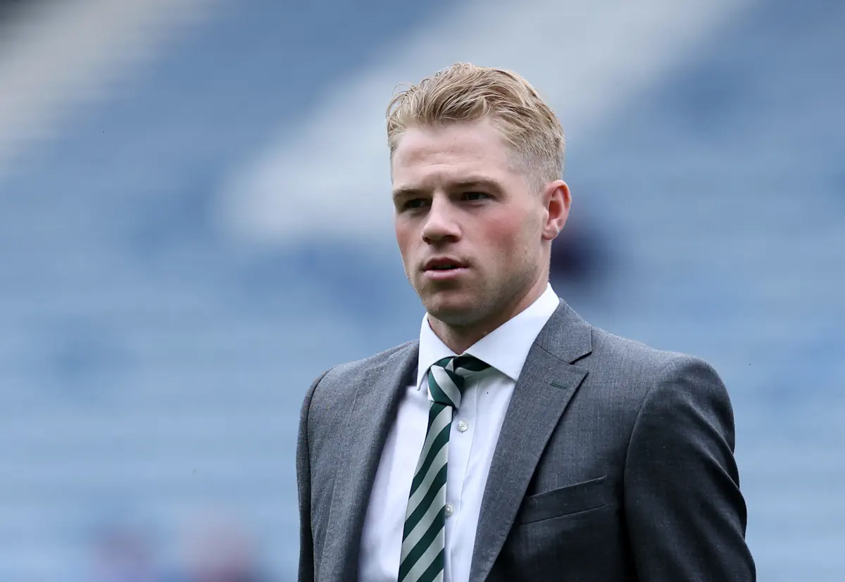 Celtic defender Stephen Welsh walks onto the pitch before the Scottish Cup final wearing a suit