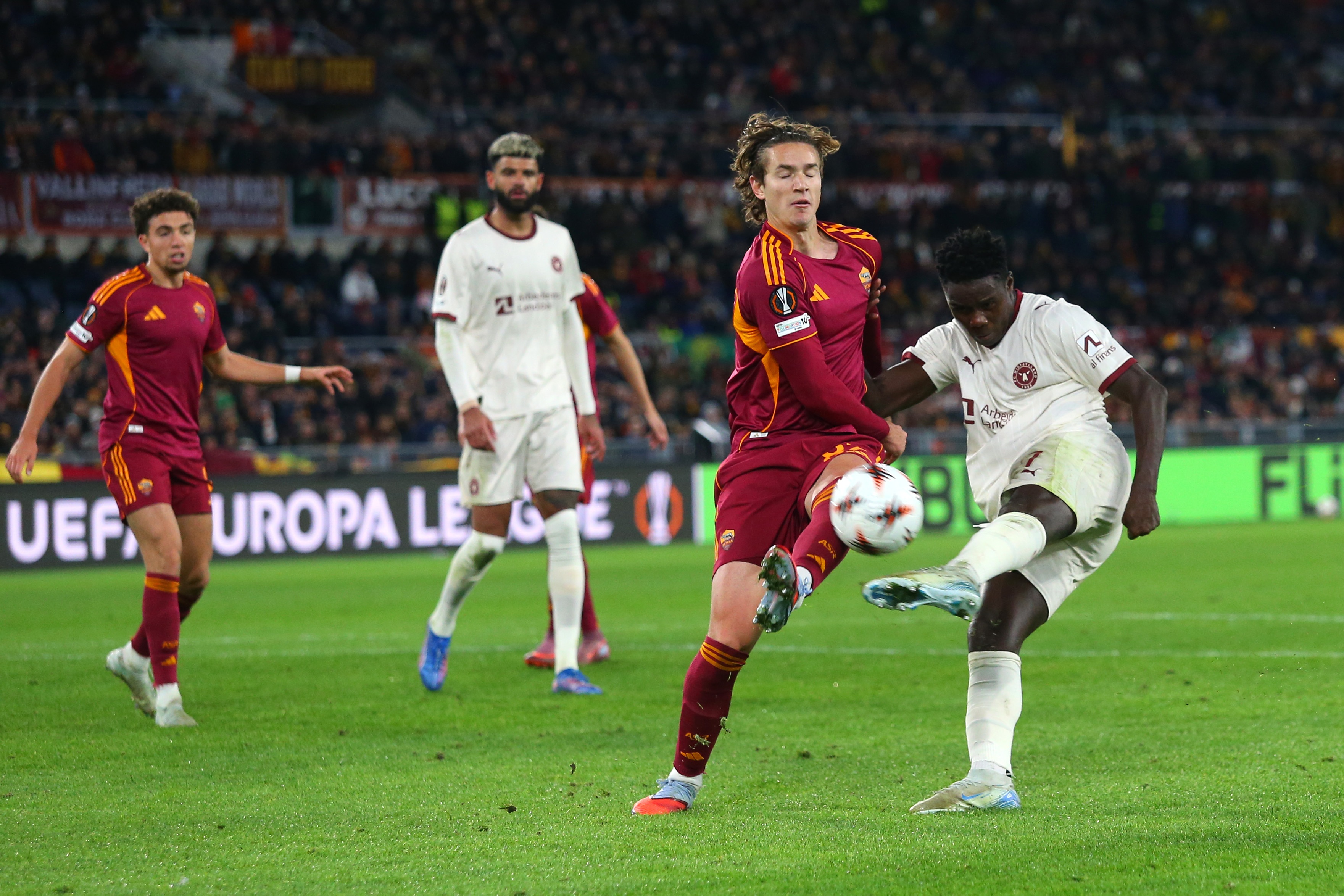 Franculino Dju competes for the ball with Roma's Daniele Ghilardi.