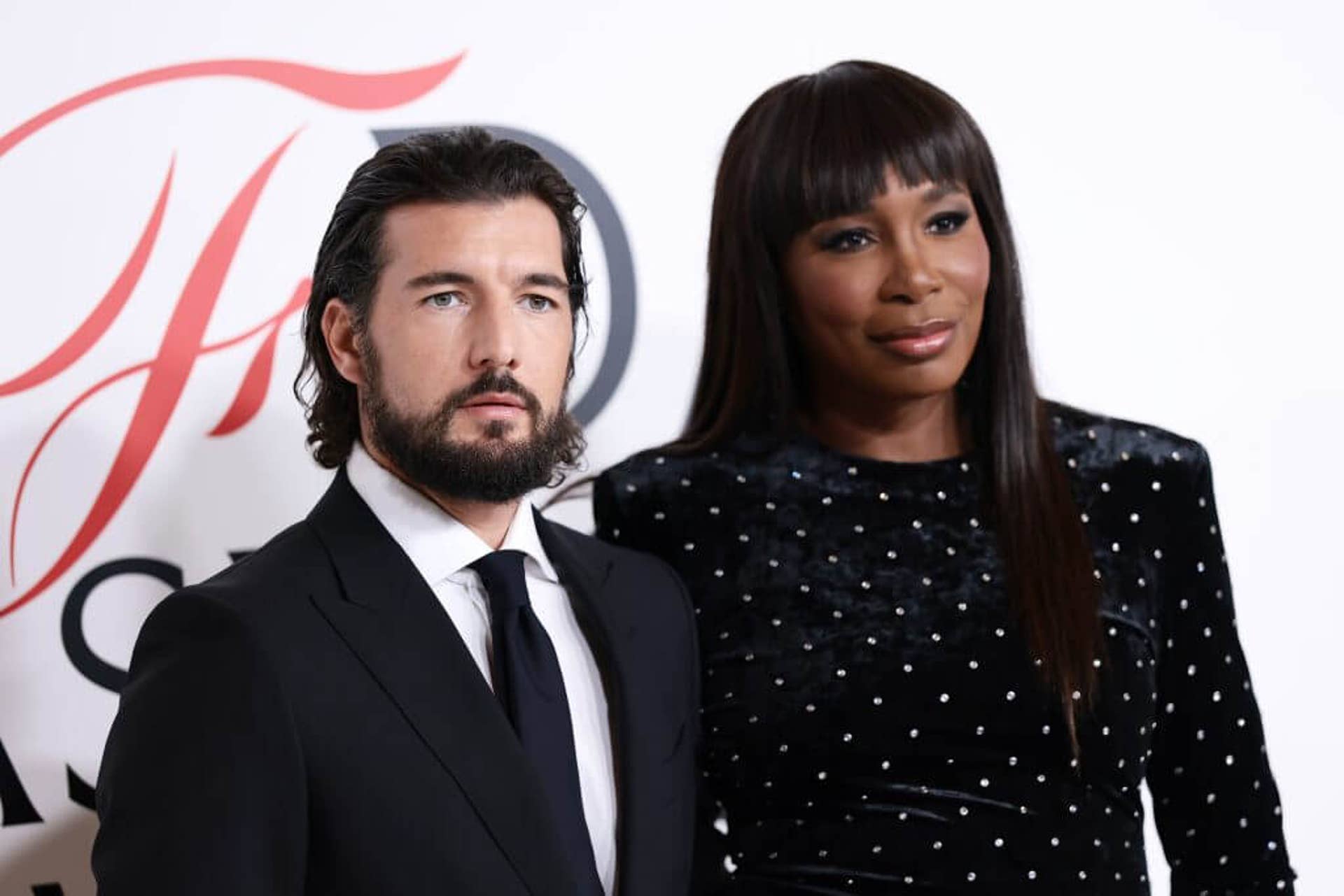 Venus Williams poses with husband Andrea Preti at event.