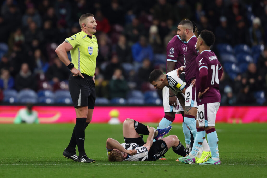 Lewis Hall goes down injured during Newcastle United's Premier League game against Burnley.