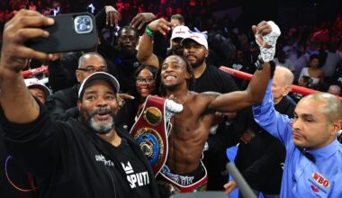 Keyshawn Davis poses with his championship belt alongside trainer Brian “BoMac” McIntyre in the ring after his second-round knockout win over Gustavo Lemos in Norfolk, Virginia.