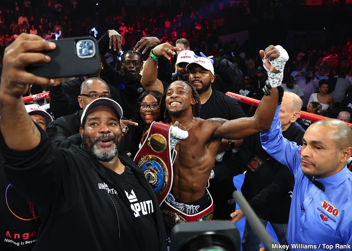 Keyshawn Davis poses with his championship belt alongside trainer Brian “BoMac” McIntyre in the ring after his second-round knockout win over Gustavo Lemos in Norfolk, Virginia.