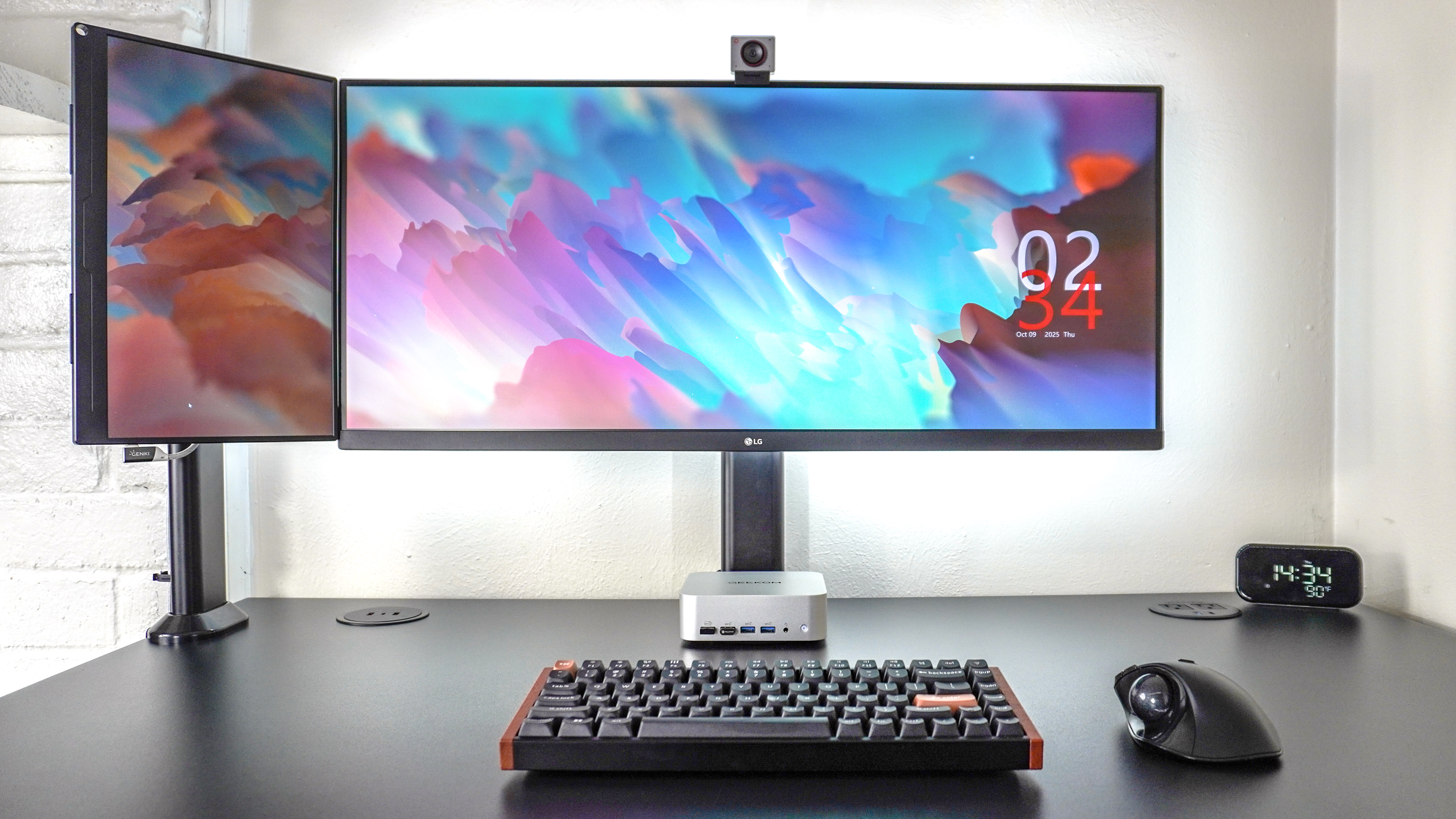 A picture of a desk setup with a portable monitor mounted next to an ultrawide