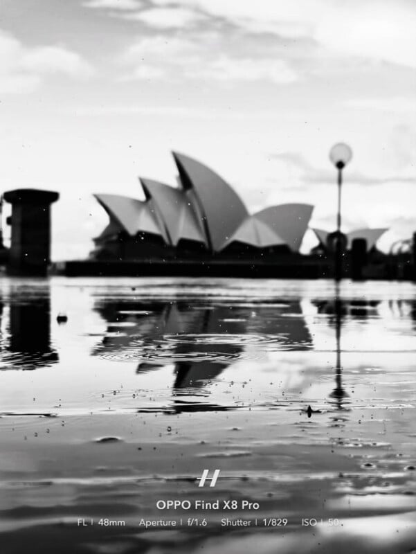 Black and white photo of the Sydney Opera House with its reflection in a large puddle; camera details and OPPO Find X8 Pro label are visible at the bottom of the image.