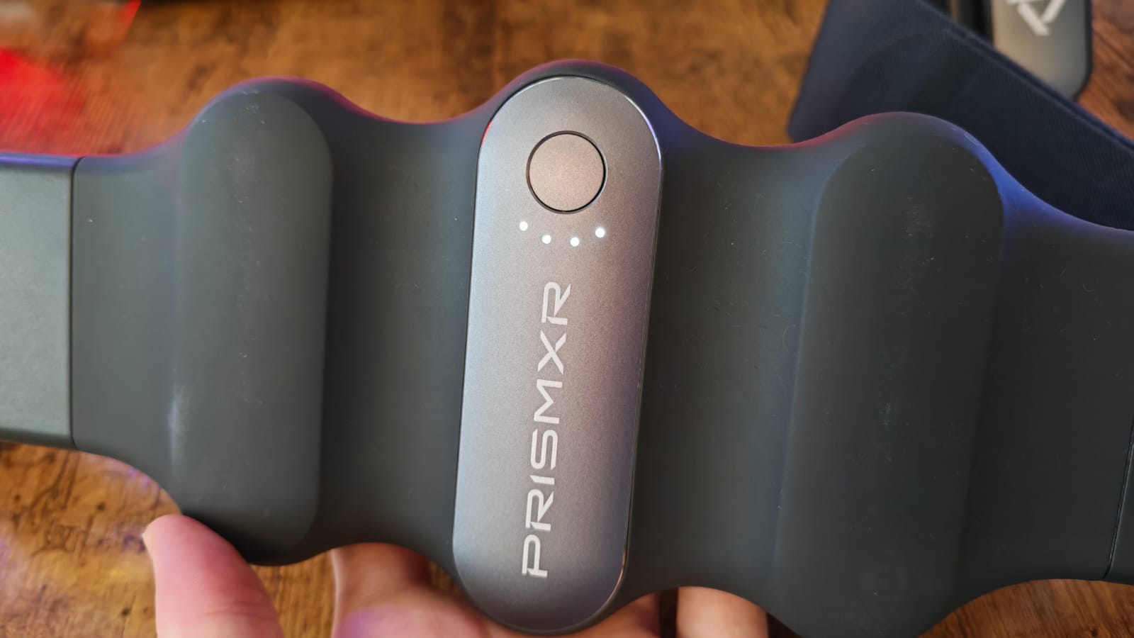 The power button and LEDs on the PrismXR Carina charging belt