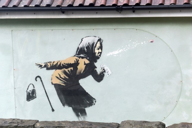 A new street artwork entitled 'Aachoo!!' by Banksy is seen in Totterdown, Bristol, Britain December 11, 2020. REUTERS/Rebecca Naden