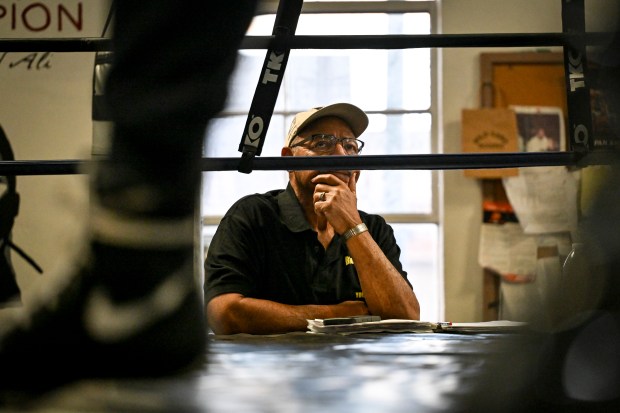Coach C.C. Edwards watches two boxers spar at Denver Police Brotherhood Youth Boxing club on Monday, Dec. 22, 2025. (Photo by AAron Ontiveroz/The Denver Post)
