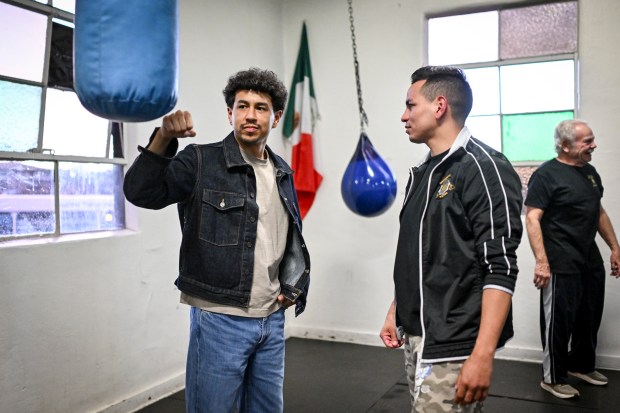 Brothers Jesus Vasquez Jr and Eduardo Vasquez talk at the Denver Police Brotherhood Youth Boxing club on Monday, Dec. 22, 2025. Both brothers grew up in the club winning state and national titles. (Photo by AAron Ontiveroz/The Denver Post)