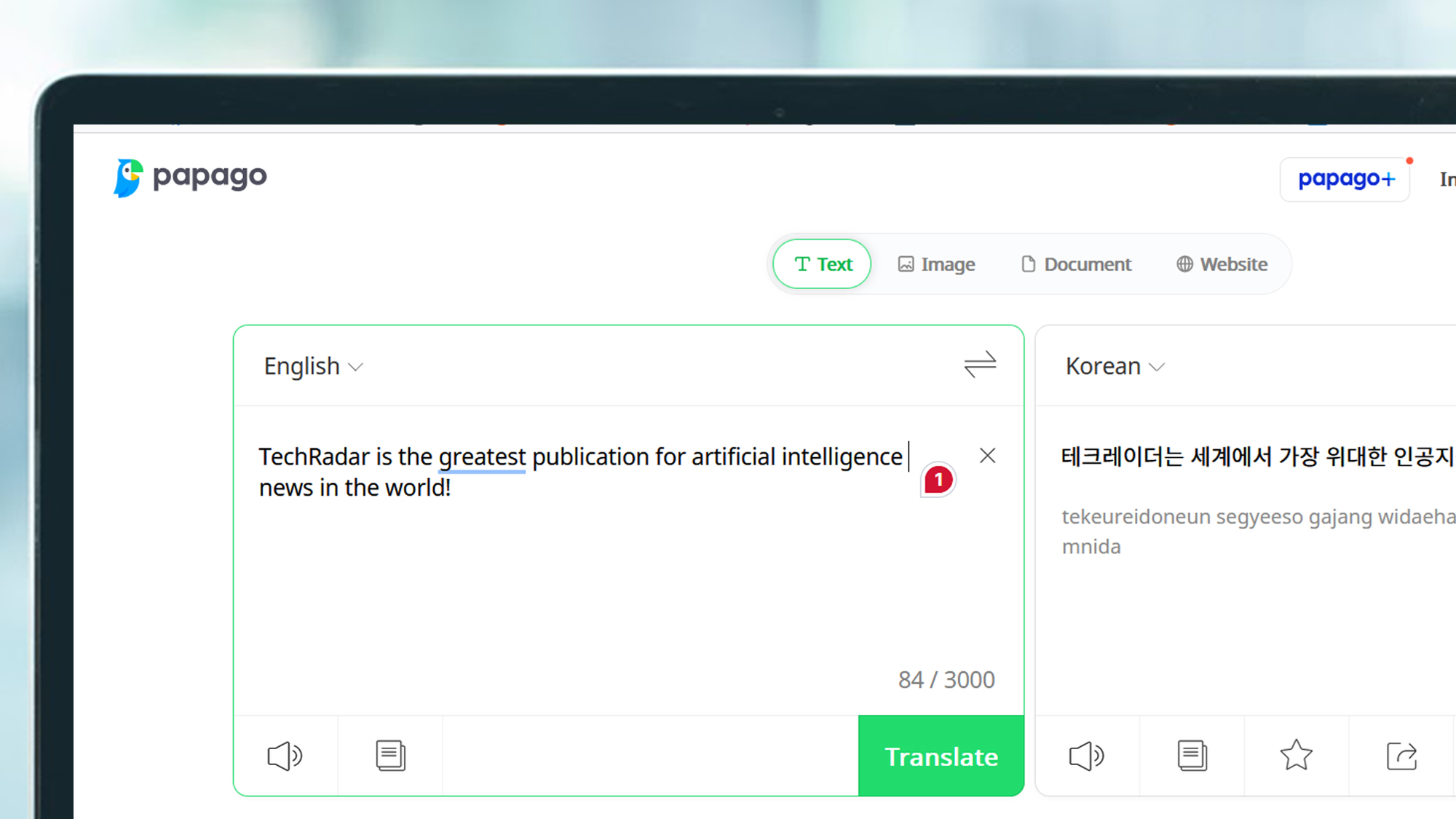 A laptop screen showing the Papago website translating a phrase