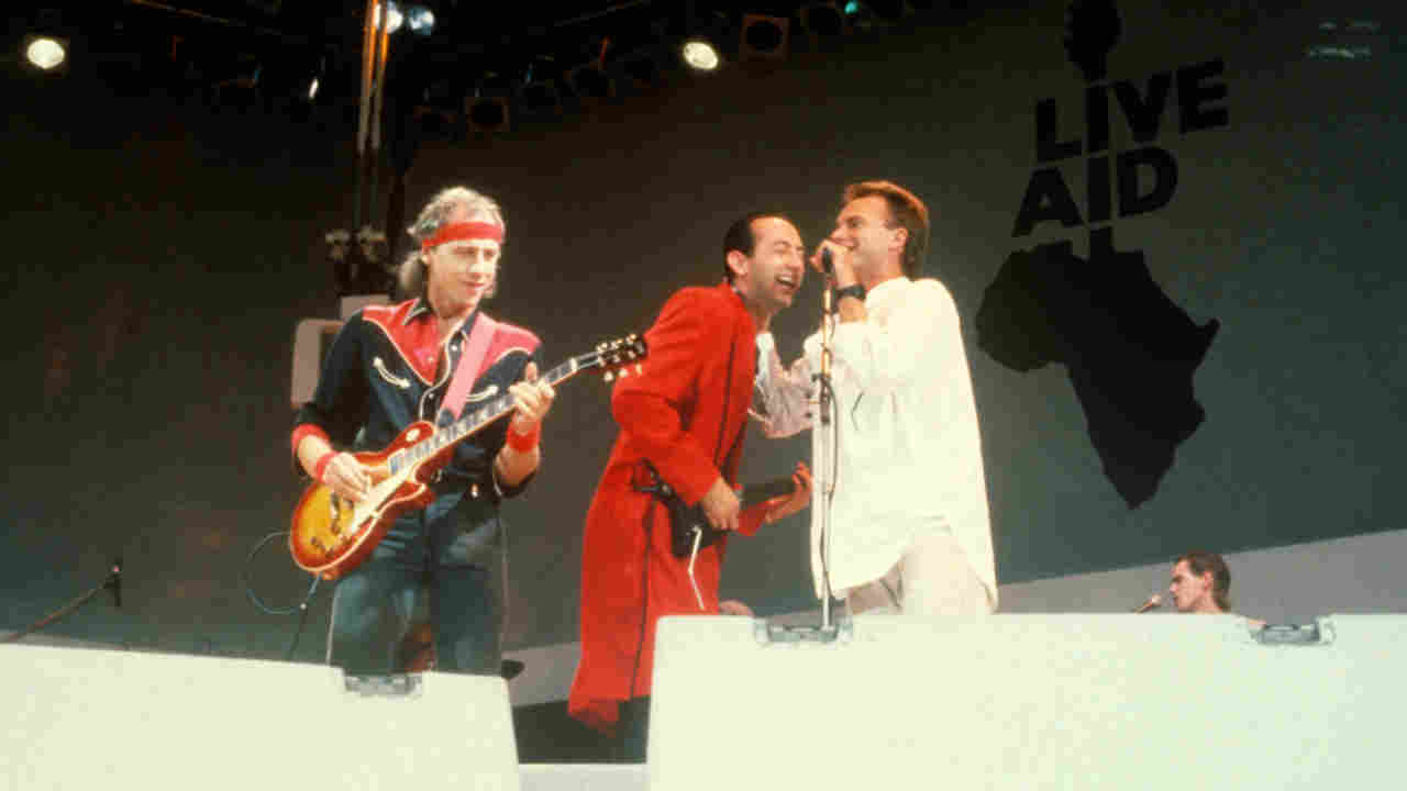 Dire Straits performing onstage at Live Aid