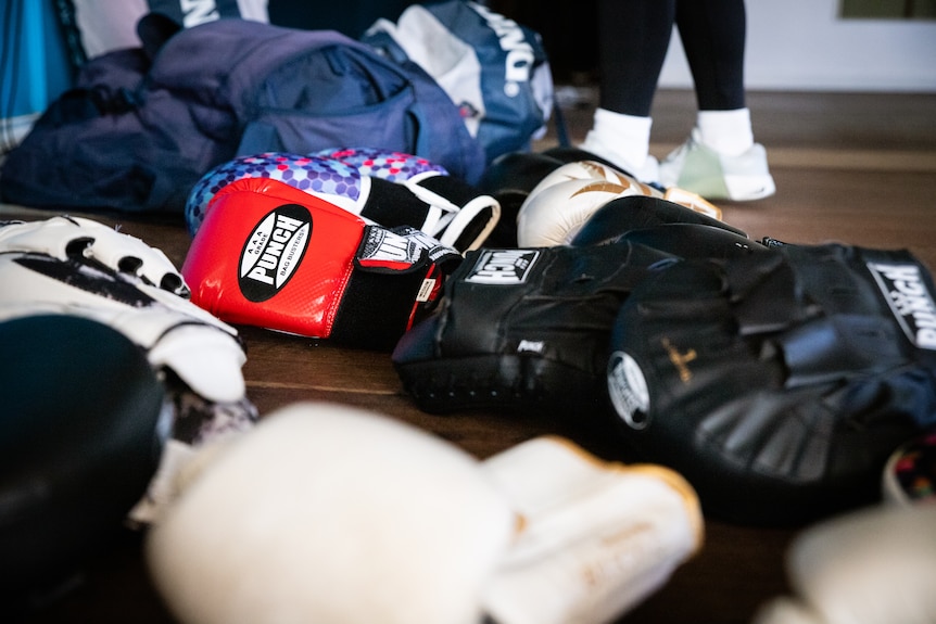 Participants smiling in a boxing class.