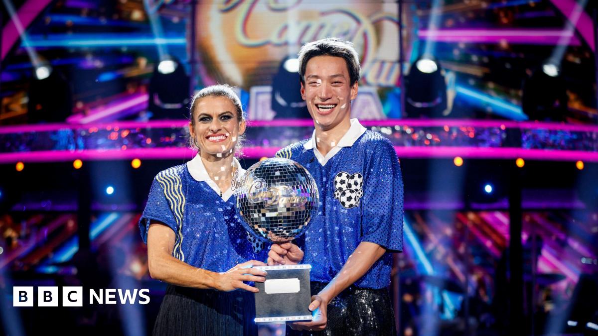 Karen Carney and Carlos Gu with their trophy after winning the 2025 series of Strictly Come Dancing