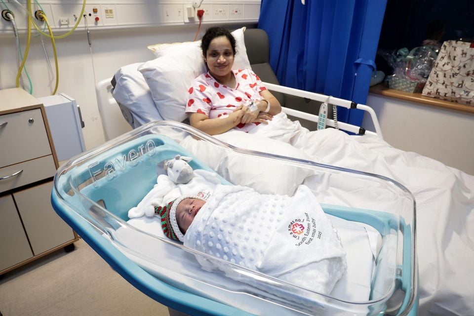 Baby Mirrah in her festive hat and special blanket alongside mum Jesna