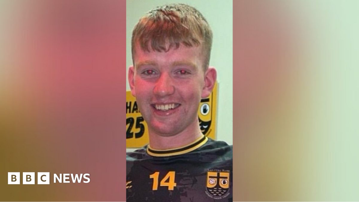 Pádraig McDonald. He has short ginger hair, wearing a black and yellow football top.