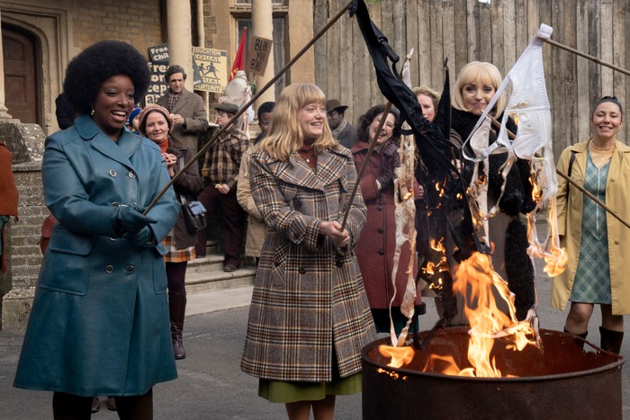 Helen George as Trixie Franklin, Natalie Quarry as Rosalind Clifford and Renee Bailey as Joyce Highland in Call the Midwife, burning their bras on a fire pit in the street.