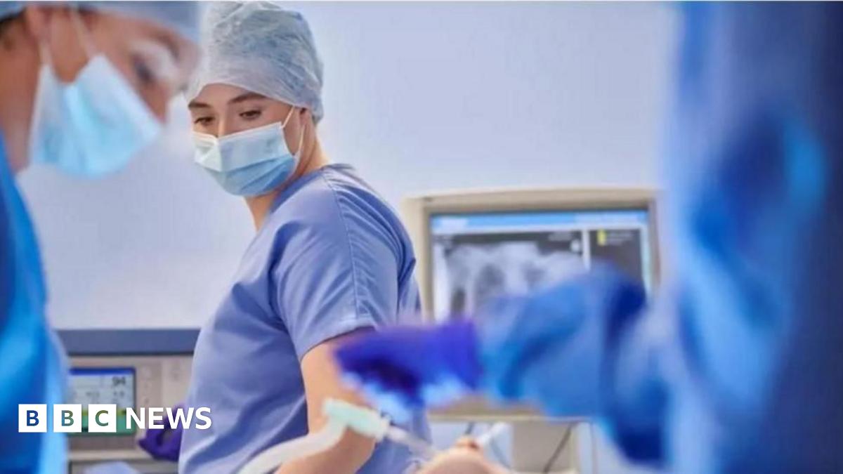 Doctors in masks in an operating theatre.